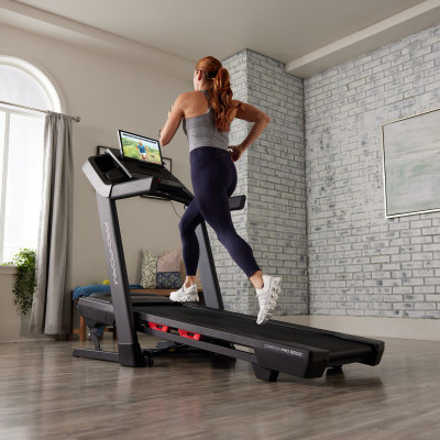 Model running at an incline on the ProForm Carbon Pro 9000 Treadmill 