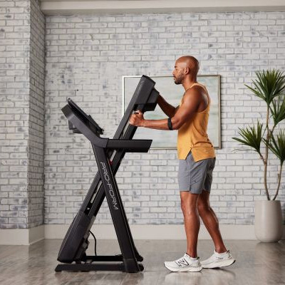 image of a model folding the ProForm Carbon TL Treadmill