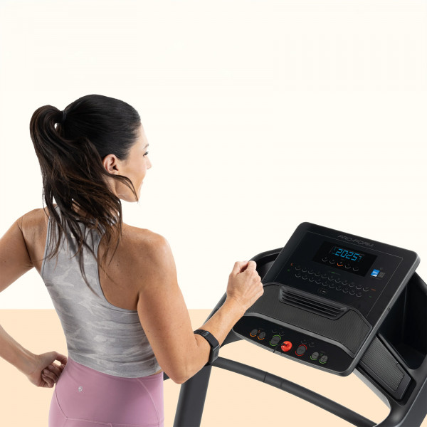 Model using the console on the ProForm Carbon TLS Treadmill