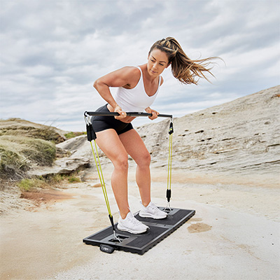 User doing bent-over row outdoors