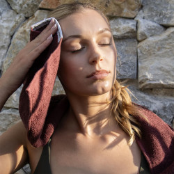 Model holding PTP Sports Pro Cotton Towel Regular - Cherry Cola to head
