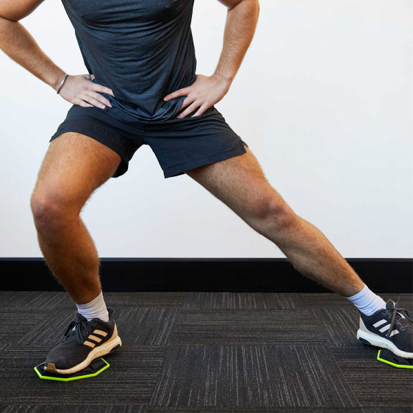 Model using the PTP Core Sliders for a lateral lunge exercise.
