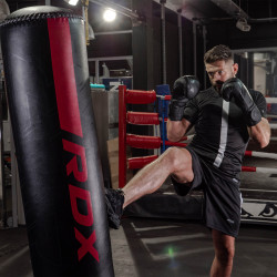 Athlete performing a kick on the RDX F6 6ft Kara Free-Standing Punch Bag.