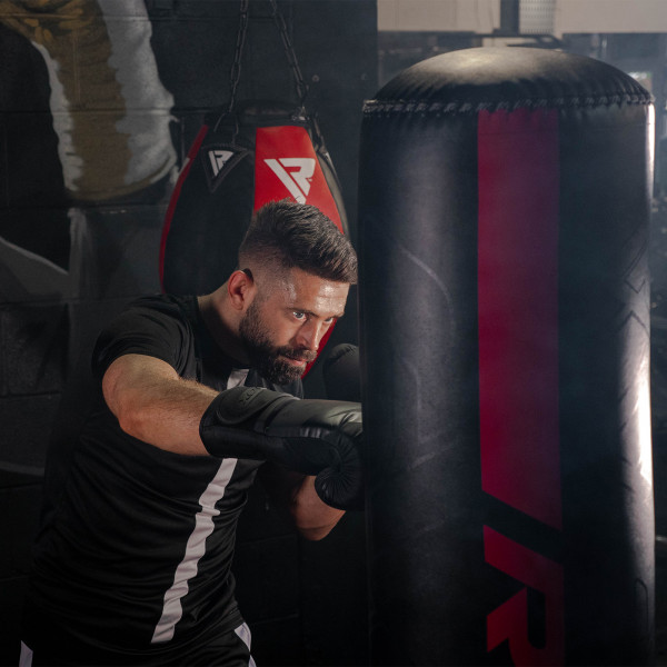 Athlete performing a punch on the RDX F6 6ft Kara Free-Standing Punch Bag.