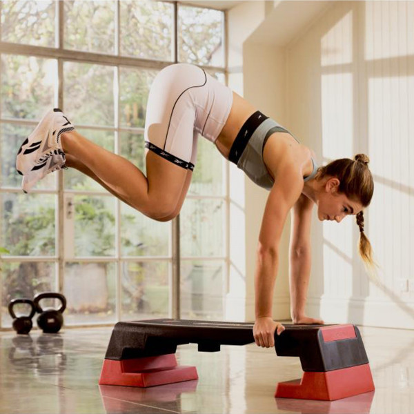 Pike tuck hold on the red Reebok Step