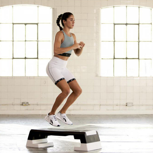 Jump squat onto the white Reebok Step