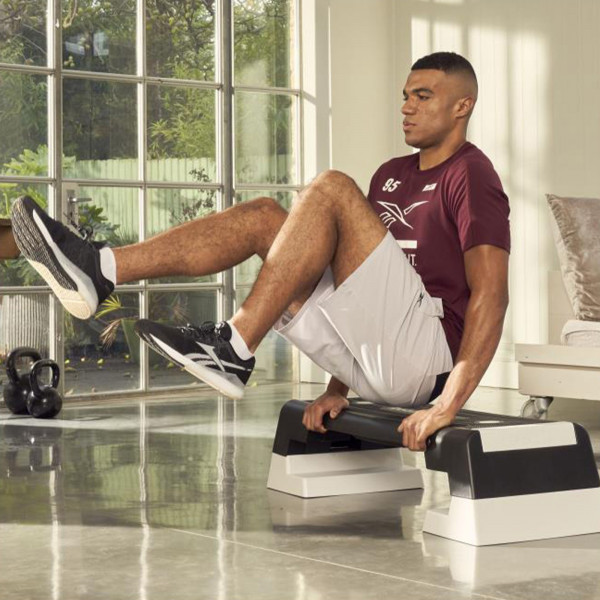 Tricep dip hold on the white Reebok Step