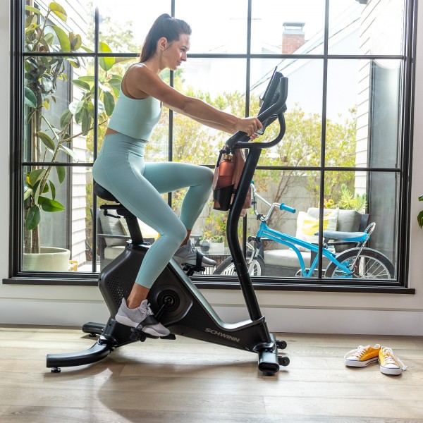 An individual engaging in an exercise session on the Schwinn 590U Upright Bike, showcasing the intensity of a workout