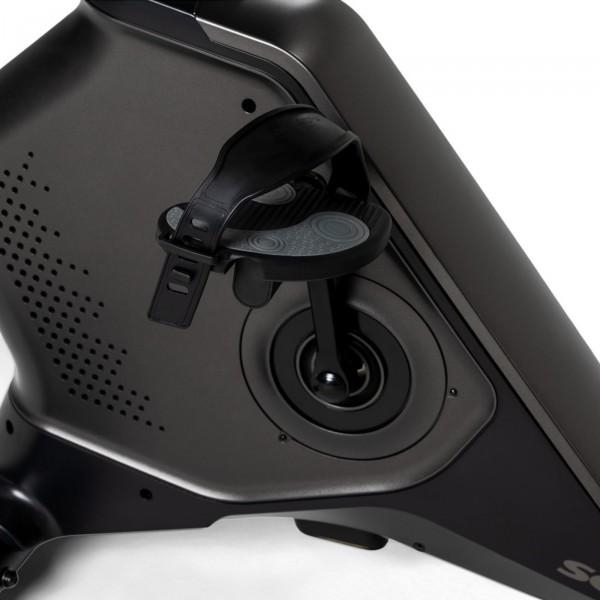 Close-up view of a textured, black bike pedal on the Schwinn 590U Upright Bike, featuring an anti-slip surface and adjustable straps for secure footing