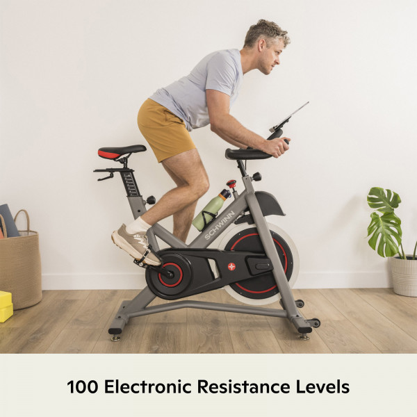 Model riding the Schwinn IC3.5 Indoor Cycle with 100 electronic resistance levels