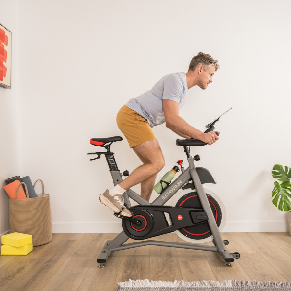 Side view of the model riding the Schwinn IC3.5 Indoor Cycle