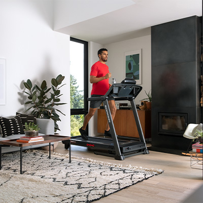 User jogging on the Schwinn 510T treadmill in living room