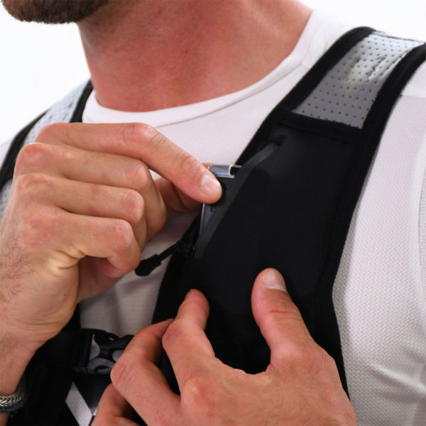 Close-up of person using pocket on the Six Peaks Hydration Running Vest in black colour (M/L)