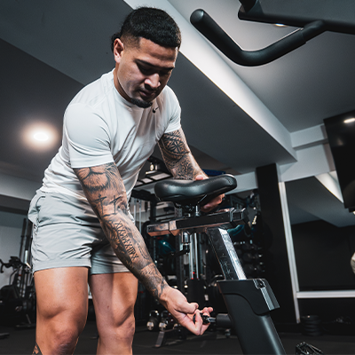 A close-up lifestyle image of the STEPR Bionic Bike XL being adjusted