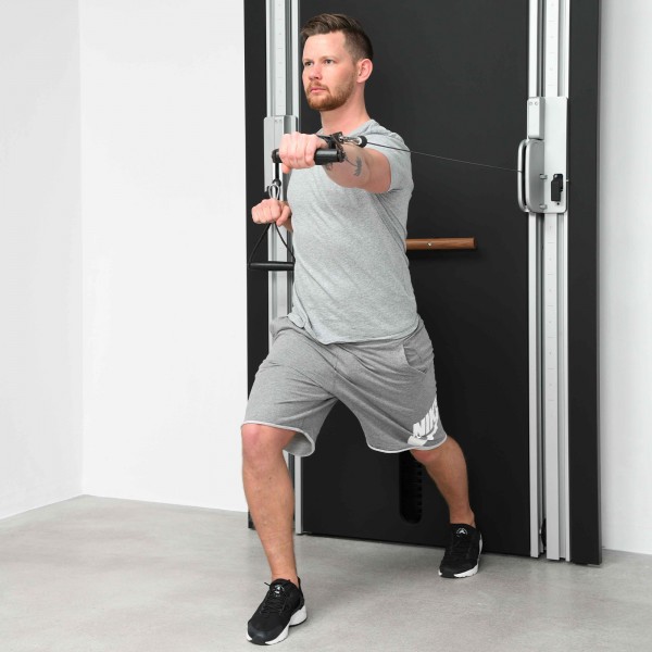 An individual during an active session on the STIL-FIT Functional Trainer PURE in black.