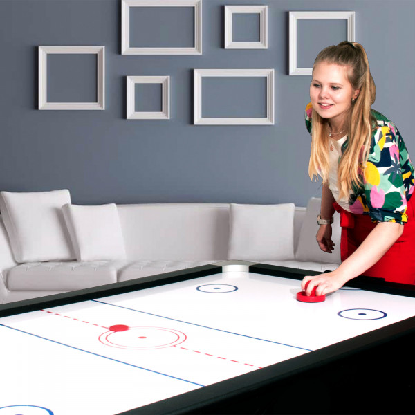 Close-up of the air hockey side of the Sure Shot 4-in-1 7ft Multi Games Table during gameplay.
