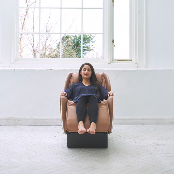 Front-facing view of user in beige Synca CirC+ Massage Chair
