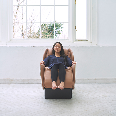 Front-facing view of user in beige Synca CirC+ Massage Chair