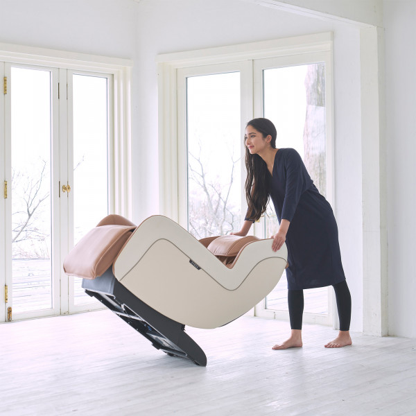 User tilting the beige Synca CirC+ Massage Chair to move it