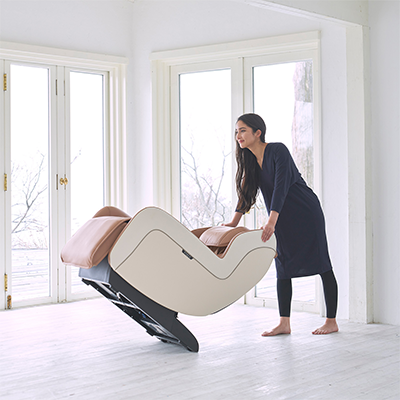 User tilting the beige Synca CirC+ Massage Chair to move it