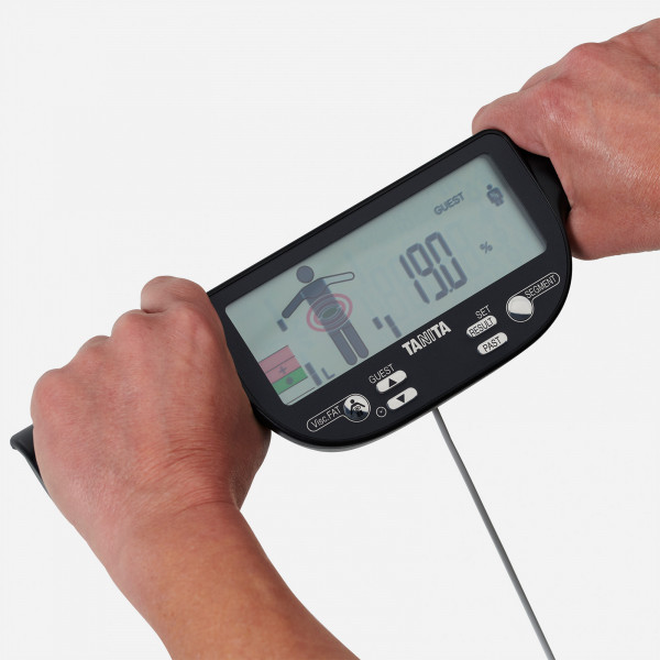 Model holding the TANITA BC-613 Segmental Body Composition Scale hand electrodes