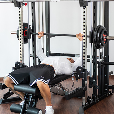 Person performing a bench press on the Taurus MS20 Pro Plate Complete Trainer.
