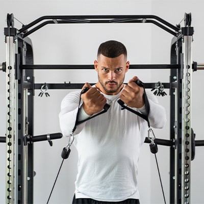 Person performing a cable crossover on the Taurus MS20 Pro Plate Complete Trainer.