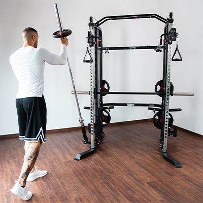 Person performing a landmine press with the Taurus MS20 Pro Plate Complete Trainer.