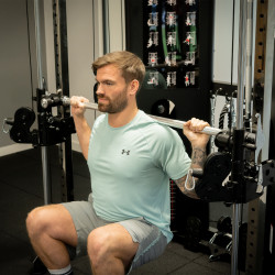 Person performing a squat using the Smith bar on the Taurus MS40 Pro Folding Multi Smith.