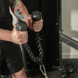 Individual exercising with the Taurus Double Tricep Rope Cable Attachment.
