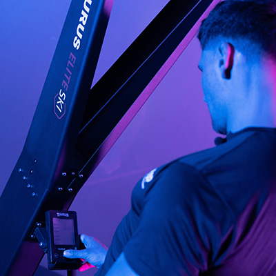 User adjusting the console settings on the Taurus Elite Ski Trainer