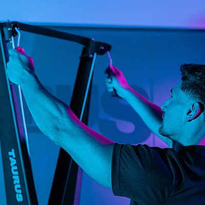 Close up of user reaching for the handles on the Taurus Elite Ski Trainer