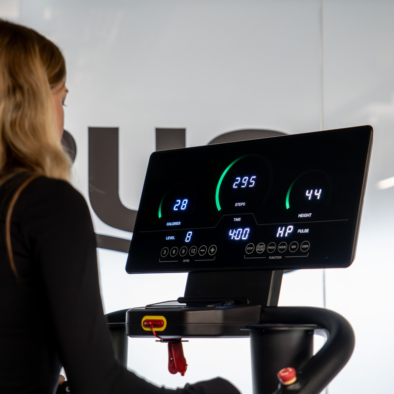 Lifestyle image of the Taurus ST9.9 Stair Trainer. The focus point of the image is the ST9.9's console, showing the workout telemetry data.