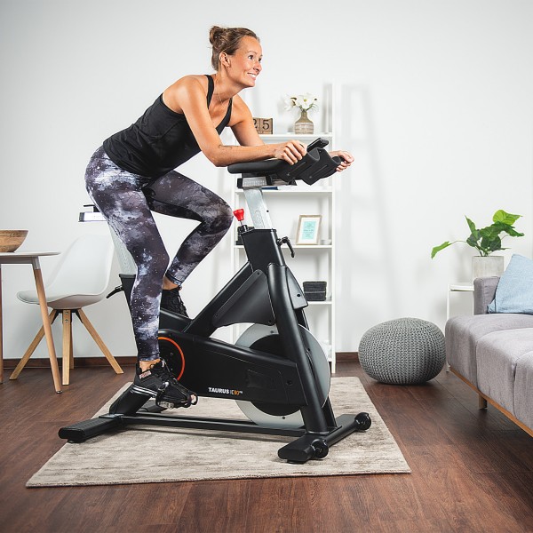 Cyclist using the Taurus IC90 Pro Exercise Bike during a workout.
