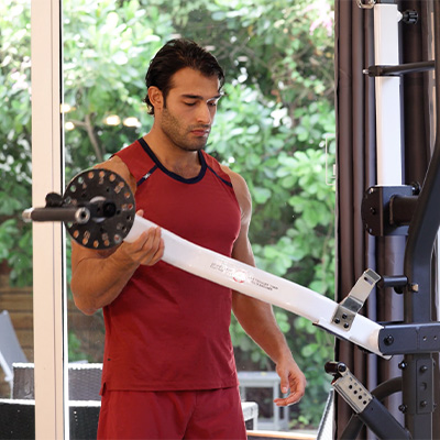 Image of a model adjusting the Taurus Flexicon Resistance Trainer arms