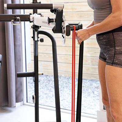 Image of a model adjusting the Taurus Flexicon Resistance Trainer resistance