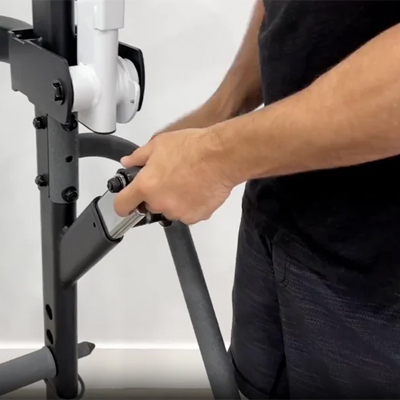 Image of a model adjusting the Taurus Flexicon Resistance Trainer stopper arms