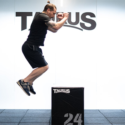 Image of a model jumping onto the Taurus 3-in-1 Plyo Box