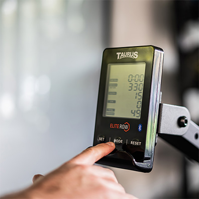 Close up of a user pressing a button on the Taurus Elite Row console