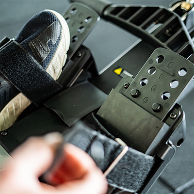 Close up of a user tightening the Taurus Elite Row foot strap