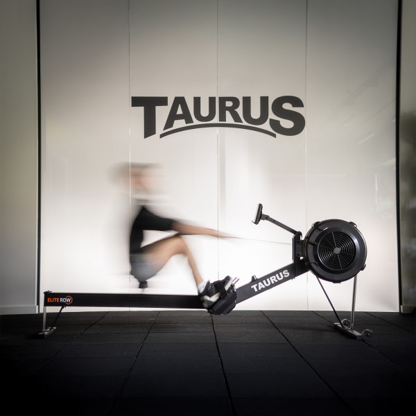 User rowing on the Taurus Elite Row in a gym setting