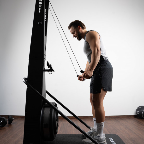 Model completing a downward pull on the Taurus Elite Ski Trainer Pro