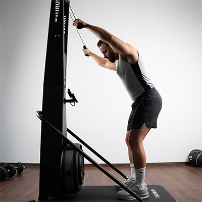 Model performing a standing double-arm pull on the Taurus Elite Ski Trainer Pro 