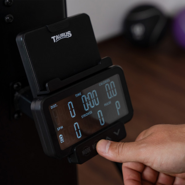 Model operating the workout console on the Taurus Elite Ski Trainer Pro