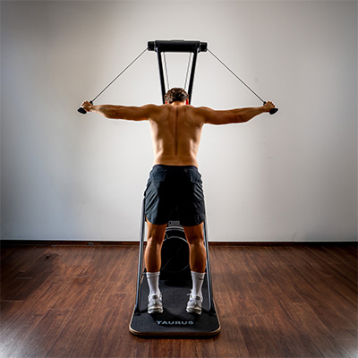 Model performing a standing double-arm pull on the Taurus Elite Ski Trainer Pro 