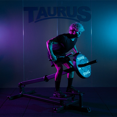 Model performing a wide grip T-Bar row