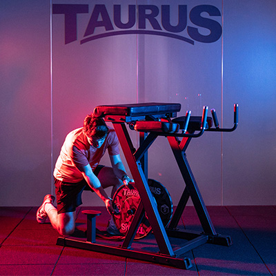 Model loading the Taurus Pro Iso Reverse Hyperextension with Olympic plates
