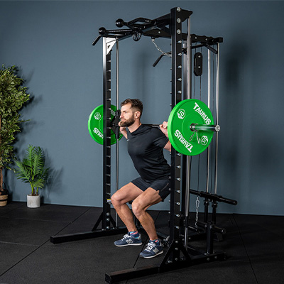 Person performing a deep squat using the Smith bar on the Taurus MS3 Pro Smith & Half Rack.