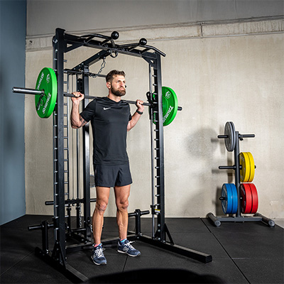 Person performing a back squat on the Taurus MS3 Pro Smith & Half Rack.