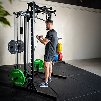 Person setting up for a triceps pushdown on the Taurus MS3 Pro Smith & Half Rack.